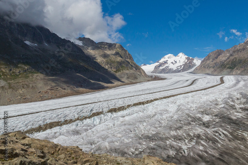 Aletsch glacier in alpine mountains in Switzerland, blue sky
