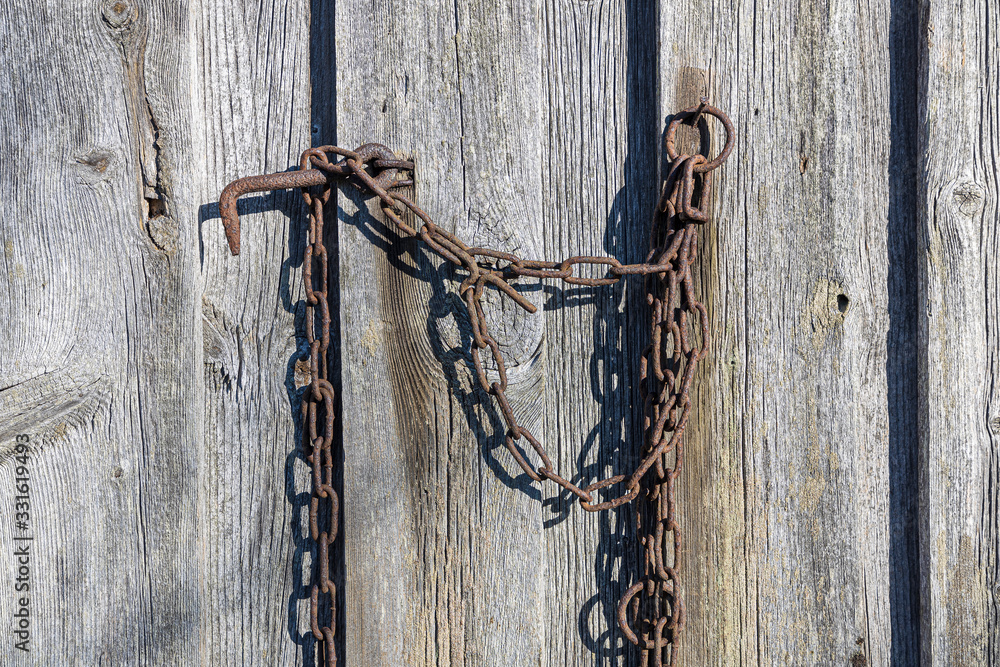 Old rusted chains near the fence Old rusted chains near the fence