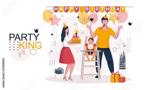 The family celebrates the birthday of the child. Mom has a birthday cake with a burning candle in her hands, daddy with a pipe in his mouth, a happy baby has raised his hands up. Family celebration.