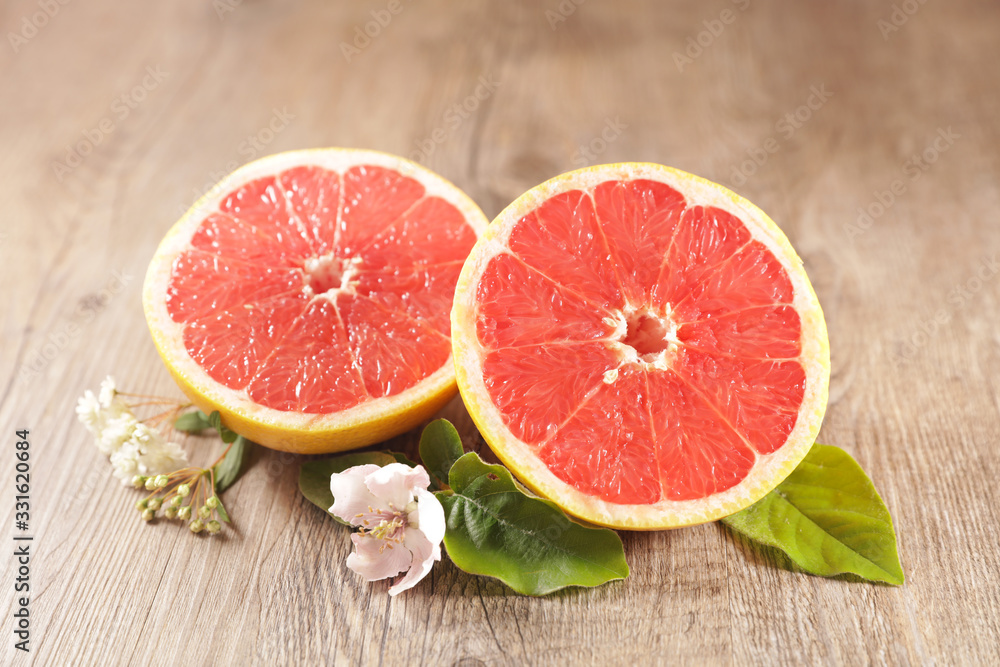 red grapefruit and leaf on wood background red grapefruit and leaf on wood background