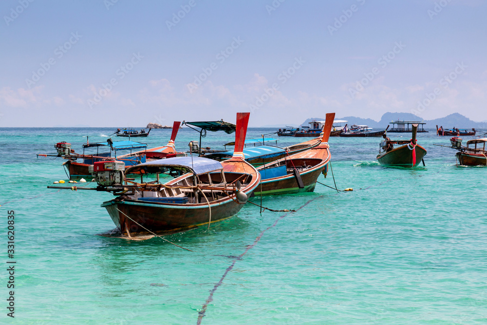 Traditional long tail boat on white sand beach in Thailand. Travel and Holiday concept, Tropical beach, long tail boats, gulf of Thailand. Long boat and tropical beach, Andaman Sea.