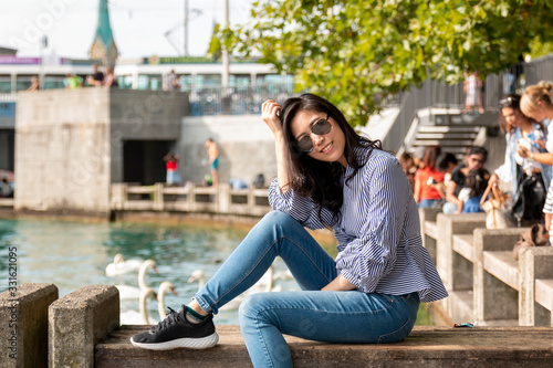 Asian women enjoying her holiday while travelling in Europe. Urban modern woman outdoor walking in Europe city. 