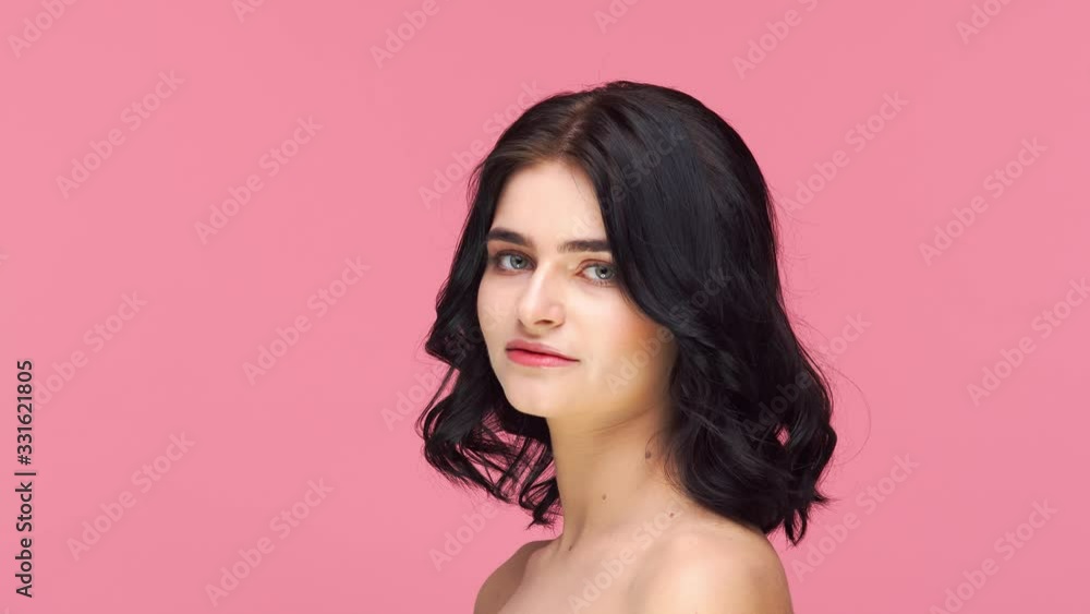 Studio portrait of young and beautiful brunette woman over pink background. Skin care, health, makeup and cosmetics. Studio portrait of young and beautiful brunette woman over pink background. Skin care, health, makeup and cosmetics.