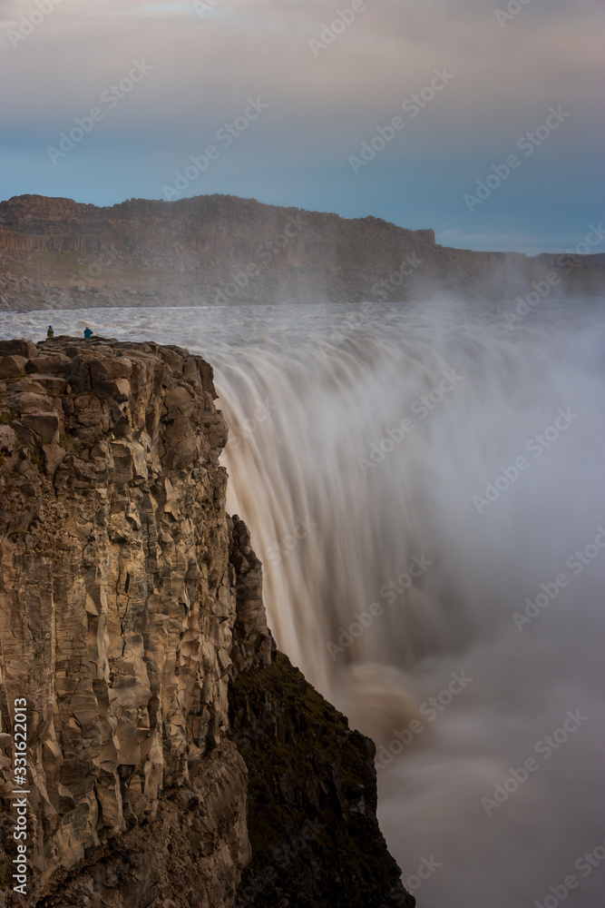 Beautiful Icelandic waterfall at sunset with huge quantity of flowing waters Iceland