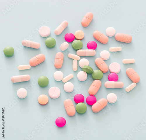 Medicine pills and capsules on pastel blue background. Health pharmacy concept