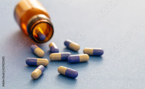 Medicine capsules on blue background. Health pharmacy concept