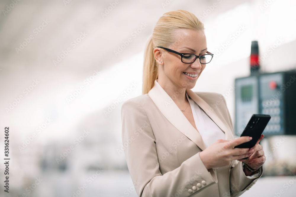 Businesswoman using phone. Young businesswoman in factory. Businesswoman using phone. Young businesswoman in factory.