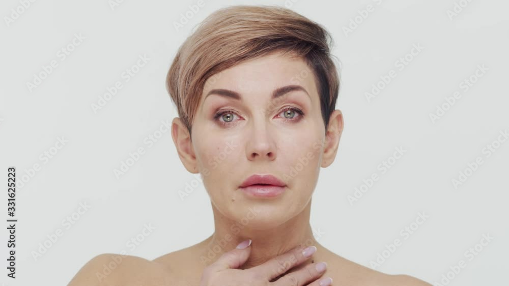 Close-up of middle aged mature woman over white bacjground. Portrait of mature lady. Plastic surgery, beauty injections and cosmetology. Close-up of middle aged mature woman over white bacjground. Portrait of mature lady. Plastic surgery, beauty injections and cosmetology.