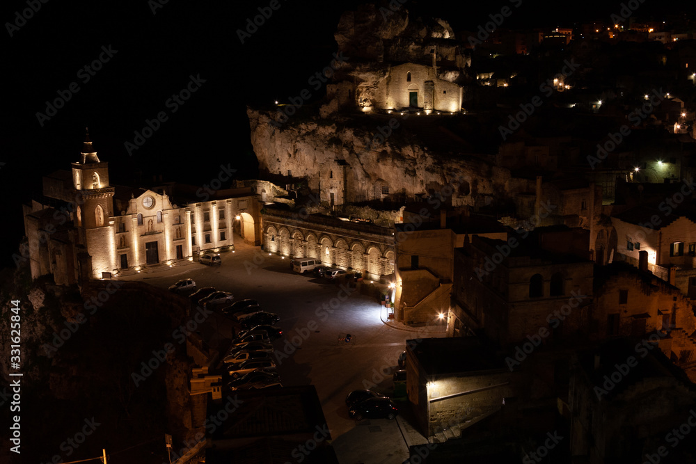 Night landscape of the Sassi of Matera a historic district in the city of Matera well-known for their ancient cave dwellings. Matera, Italy, Basilicata, Italy