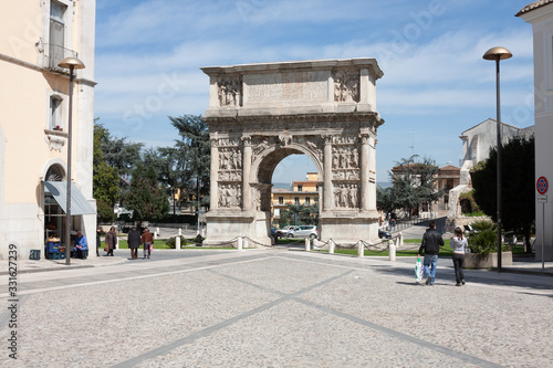 Benevento, Campania, Italy: people walking near the arch of Trajan