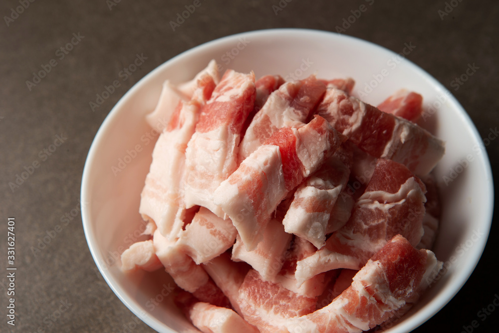 Fresh raw pork in white bowl Fresh raw pork in white bowl