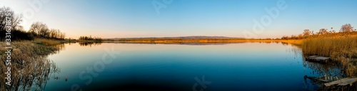 colorful panorama of autumn lake on a bright sunny day