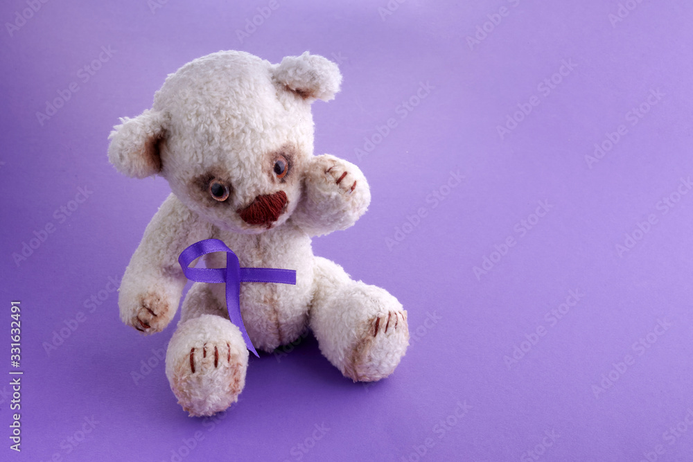 Epilepsy day.Health care concept. Teddy bear with purple ribbon. Epilepsy or Cancer hope.