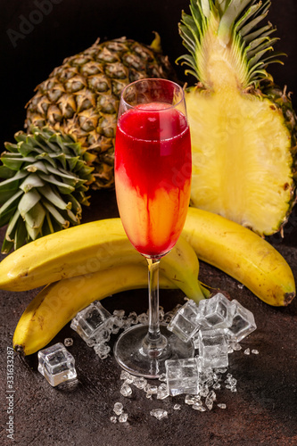 Delicious icy cocktail with fruits on dark grounge background. Healthy colorfull fruit shakes with ice on textured table. photo