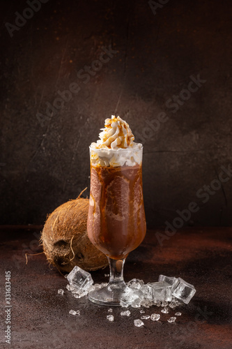 Delicious icy cocktail with fruits on dark grounge background. Healthy colorfull fruit shakes with ice on textured table. photo