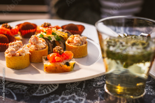 savoury afternoon tea items such as tuna tarts, sushi, salmon  sandwiches, chocolate pralines on a river cruise in Xixi Wetland, Hangzhou China photo