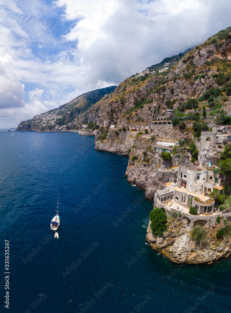Aerial view of the seashore of southern Italy. Boat. Incredible beauty panorama of mountains and sea. Travel and tourism. Summer day. Fiordo di furore beach. Praiano, Amalfi coast. Vertical photo