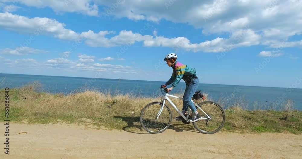 Young woman bicycle rider in sunny summer day Young woman bicycle rider in sunny summer day