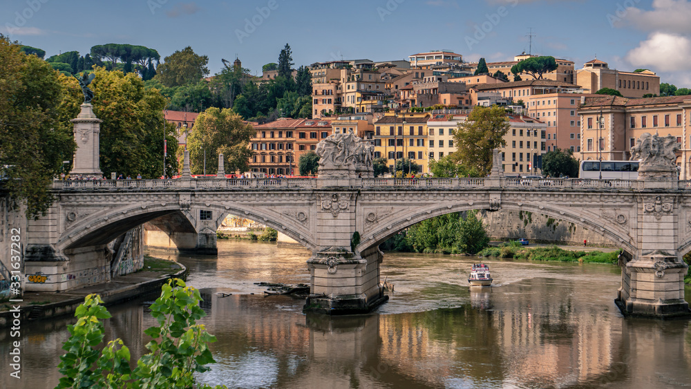 A bridge over the Tiber River near St. Peter's Basilica and the Vatican in Rome, Italy.
