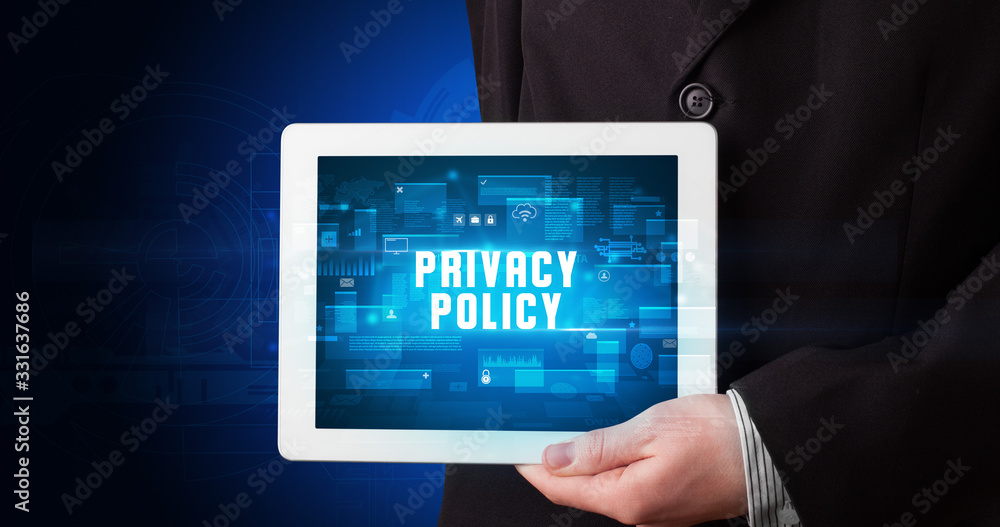 Young business person working on tablet and shows the digital sign: PRIVACY POLICY Young business person working on tablet and shows the digital sign: PRIVACY POLICY