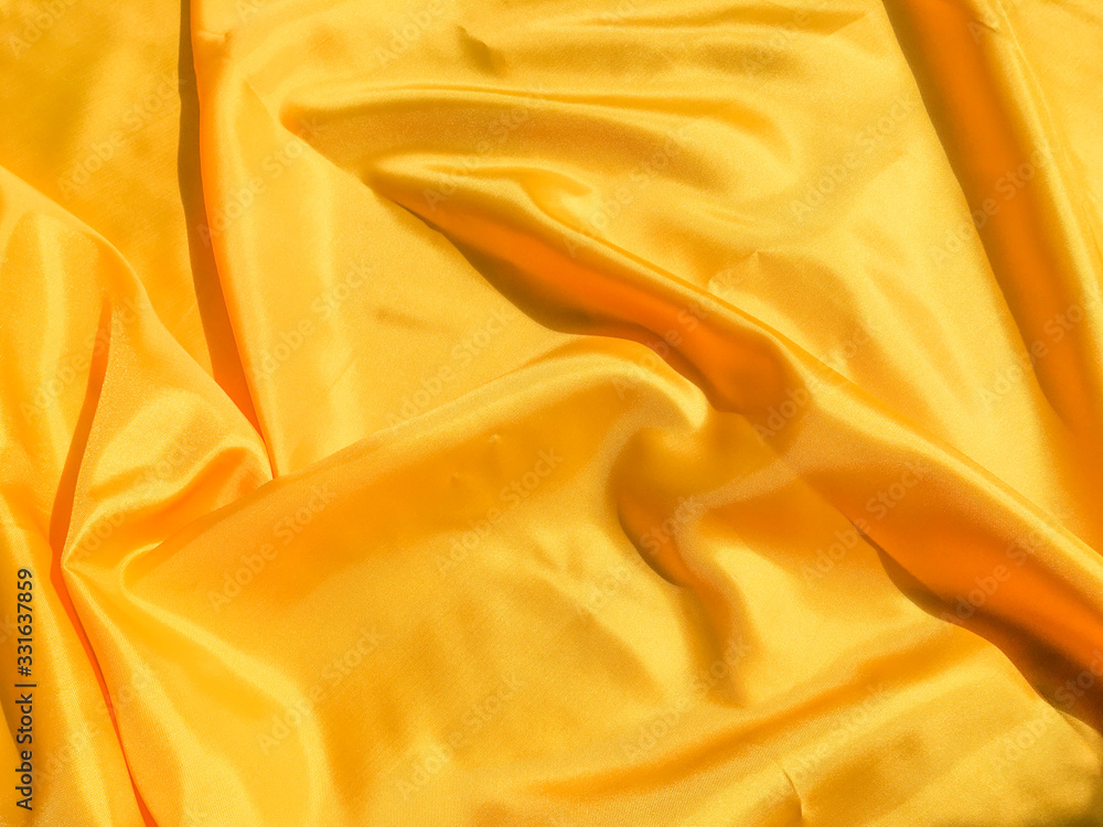 Beautiful yellow silk or satin texture background with copy space for design and artwork Beautiful yellow silk or satin texture background with copy space for design and artwork