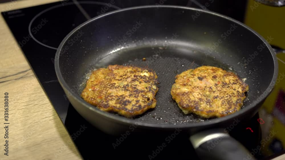 Baking vegan pancakes on the black pan. Homemade pancakes frying on a pan with olive oil in the kitchen. Breakfast in the pan. Baking vegan pancakes on the black pan. Homemade pancakes frying on a pan with olive oil in the kitchen. Breakfast in the pan.