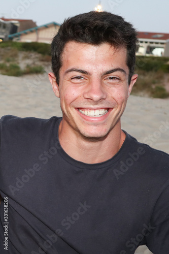 Young caucasian smiling happy man on the street laughing