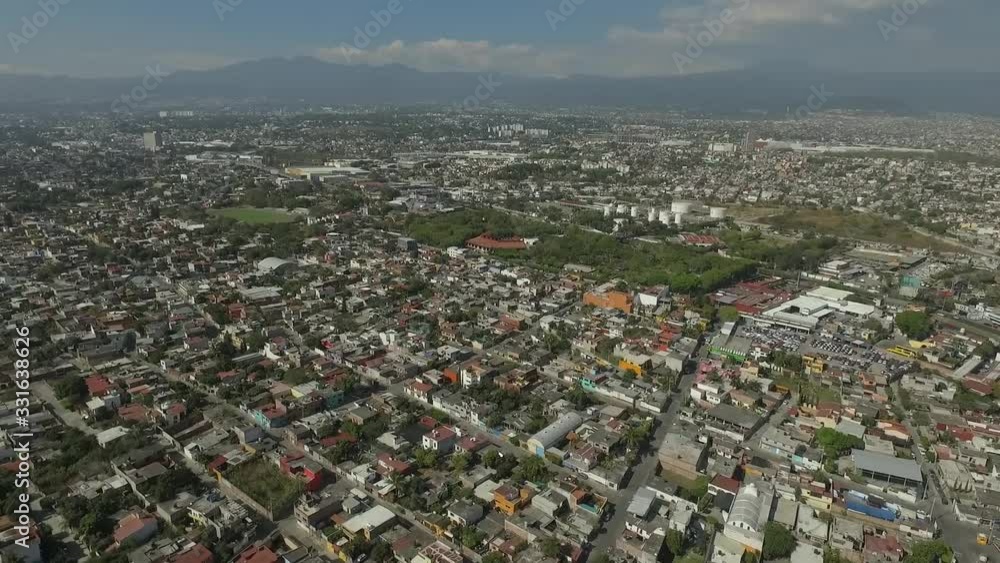 Aerial view of houses and a park in a Mexican town.