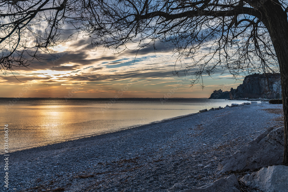 Obraz premium Winter sunset over the bay of Portopiccolo Sistiana. Duino. Italy