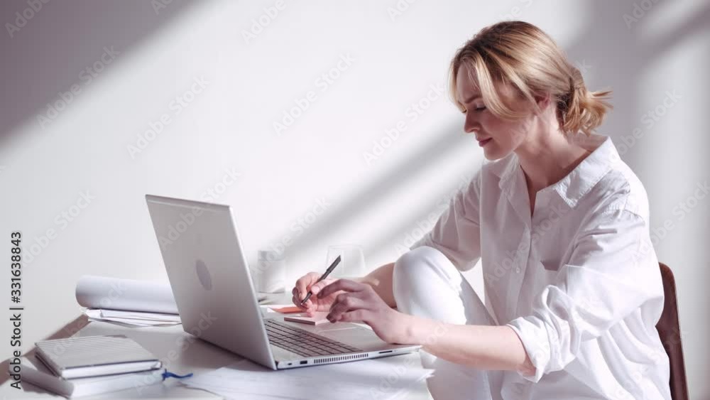 Lifestyle of a modern woman; works or communicates in a sunny home Lifestyle of a modern woman; works or communicates in a sunny home
