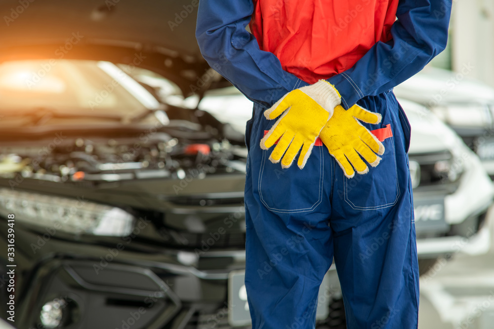 Portrait of mechanic standing in repair shop,Service concept,Repair of machines,Repair specialist,Technical maintenance. Portrait of mechanic standing in repair shop,Service concept,Repair of machines,Repair specialist,Technical maintenance.