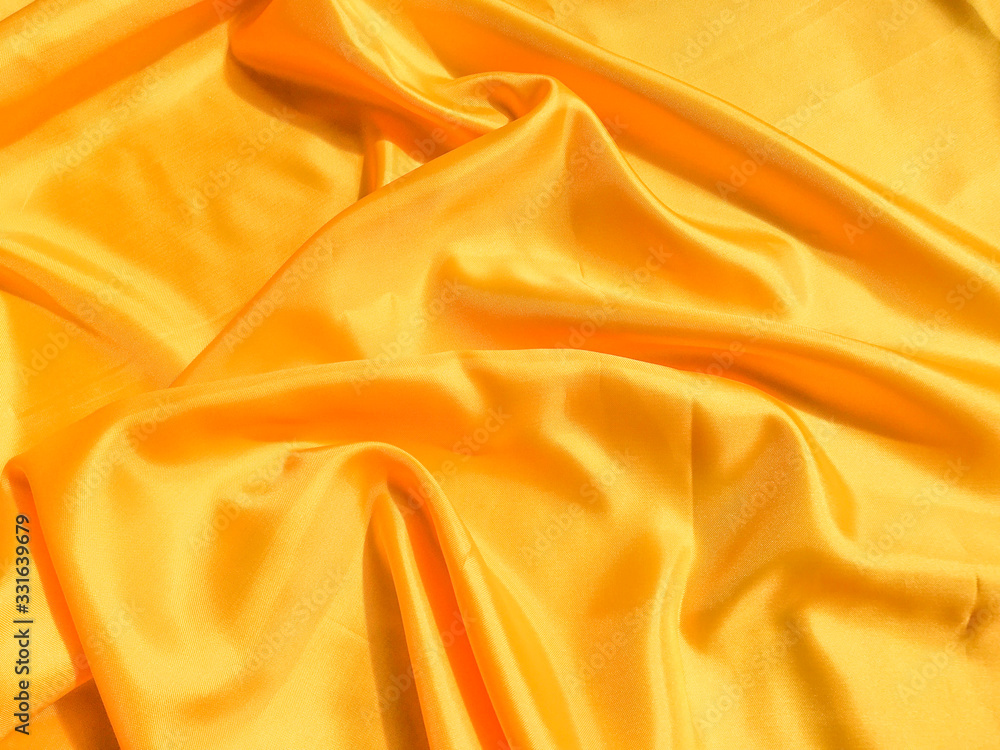 Fototapeta premium Minimal yellow fabric texture background. smooth elegant wavy light with cpoy space