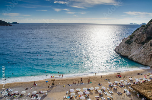 Fototapeta Naklejka Na Ścianę i Meble -  Antalya, Kas region,Turkey - September, 28, 2015: The famous Kaputas Beach. People entering the sea and the beach. Beach umbrellas and sunbeds. View of the beach from above.