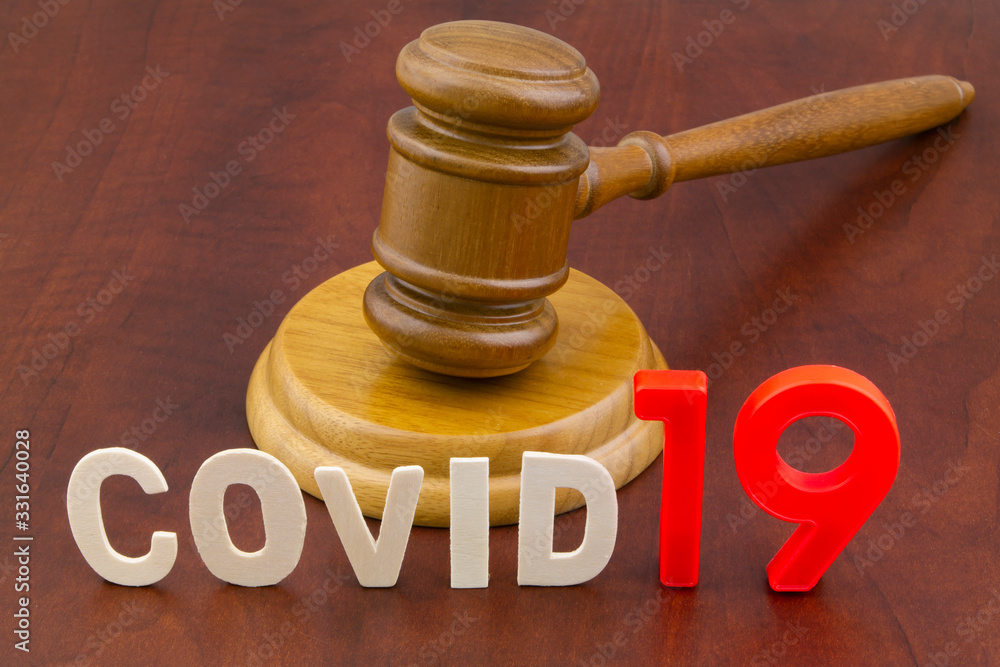 Wooden gavel with word covid19. Concept of quarantine and law against covid-19. Wooden gavel with word covid19. Concept of quarantine and law against covid-19.