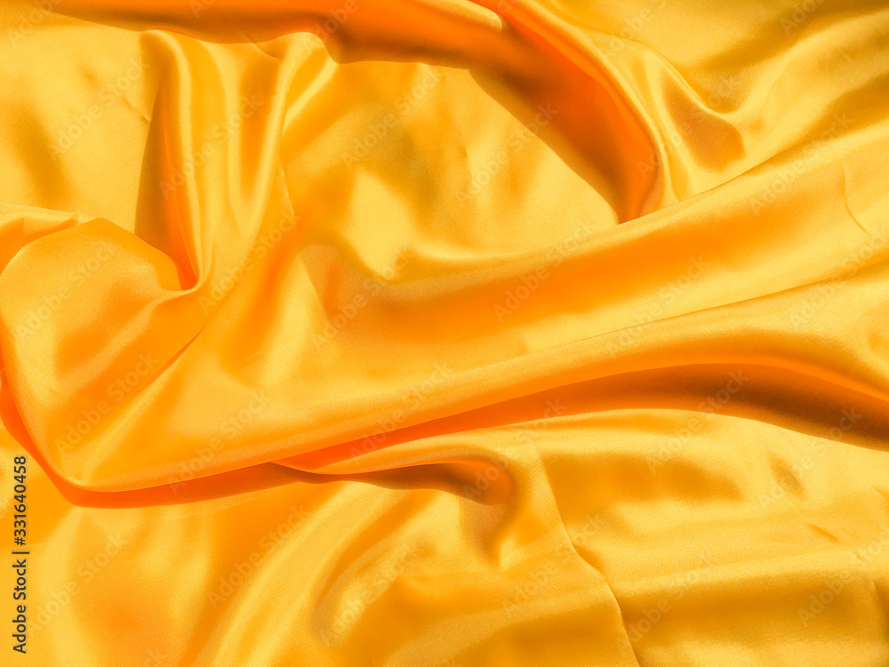 Yellow silk or satin texture background with copy space for design Yellow silk or satin texture background with copy space for design