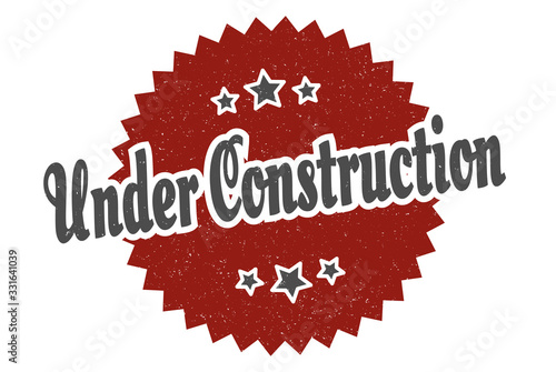 under construction sign. under construction round vintage retro label. under construction