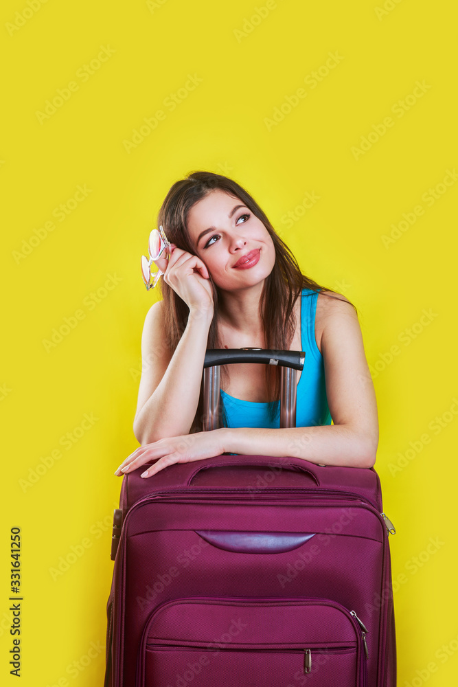 happy woman girl in sunglasses with suitcase on yellow background happy woman girl in sunglasses with suitcase on yellow background