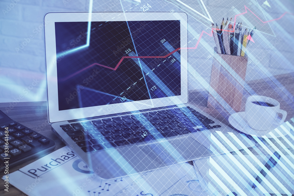 Forex market chart hologram and personal computer background. Multi exposure. Concept of investment. Forex market chart hologram and personal computer background. Multi exposure. Concept of investment.