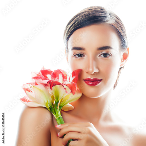 young pretty brunette woman with red flower amaryllis close up isolated on white background. Fancy fashion makeup  bright lipstick  creative Ombre manicured nails. spa skin care