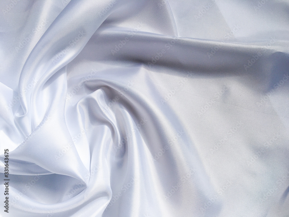 Fototapeta premium white crumpled fabric texture background. Silk curtain with fold waves for design