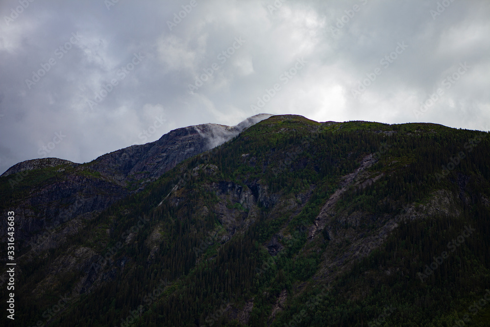 Fog in the Norwegian mountain forests. Dramatic Smoky Mountains Fog in the Norwegian mountain forests. Dramatic Smoky Mountains