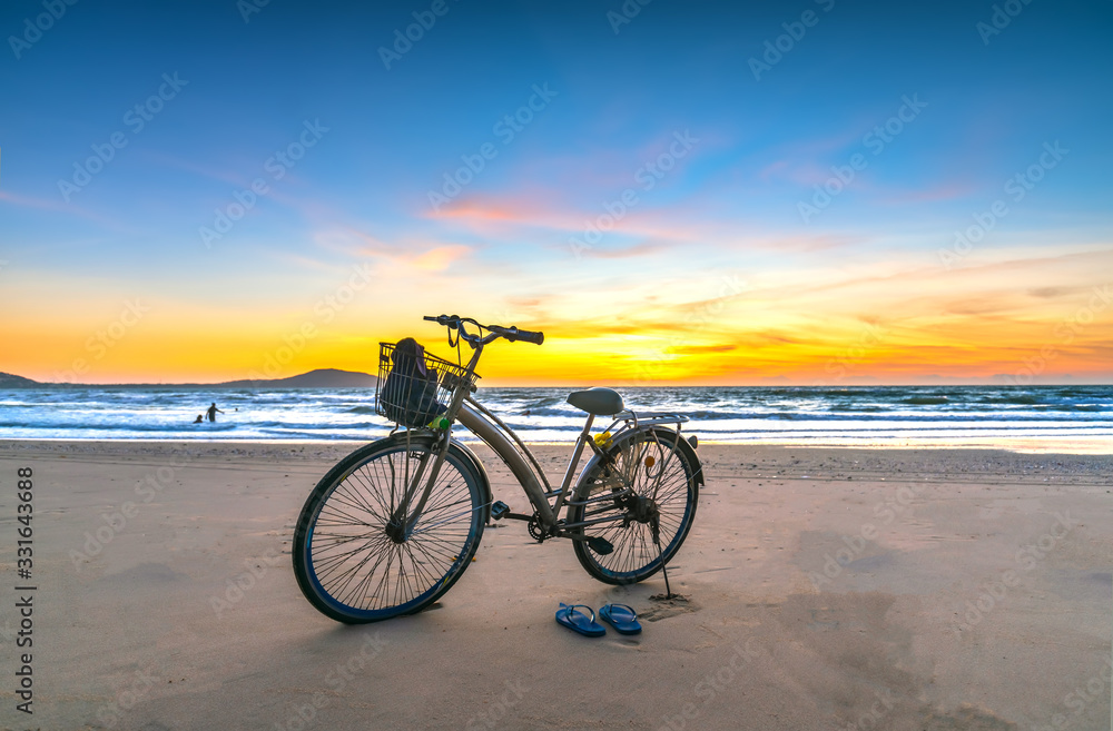 A bike by the beautiful beach at dawn, this is a means for a coastal walk of fishermen A bike by the beautiful beach at dawn, this is a means for a coastal walk of fishermen