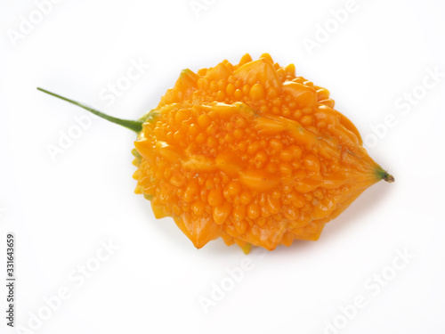 ripe bitter gourd, balsam apple or bitter cucumber and carilla fruit isolated on white background use as ingredient in cosmetic product and is a medicinal herb, close up shot photo. photo