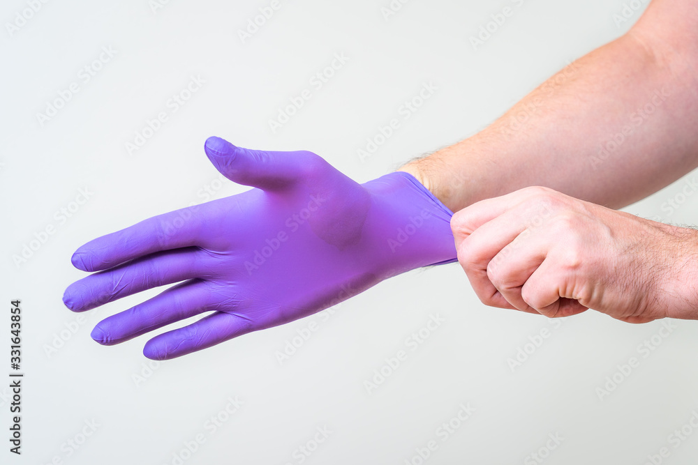 Male hand pulling a glove on
