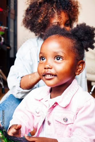 adorable sweet young afro-american mother with cute little daughter, hanging at home, having fun playing smiling, lifestyle people concept, queen girl