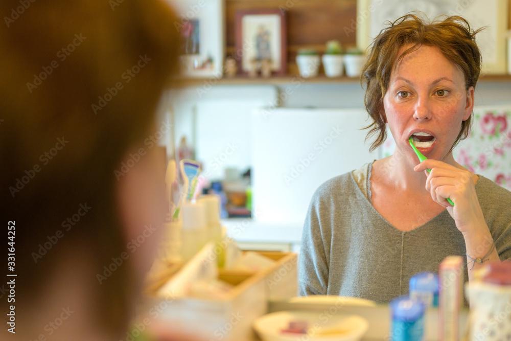Hispanic woman cleaning her teeth in the morning Hispanic woman cleaning her teeth in the morning