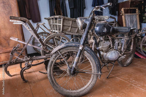 Old wagon and motorcycle in a cottage in Stircea, small village in Glodeni District of Moldova photo