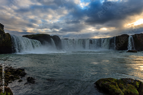 Beautiful Icelandic waterfall at sunset with huge quantity of flowing waters Iceland