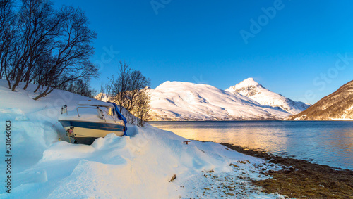 Wallpaper Mural Kaldfjord, Troms og Finnmark / Norway - March 4th, 2020: Small recreational boat buried in the snow on the banks of a fjord in the Arctic Ocean Torontodigital.ca
