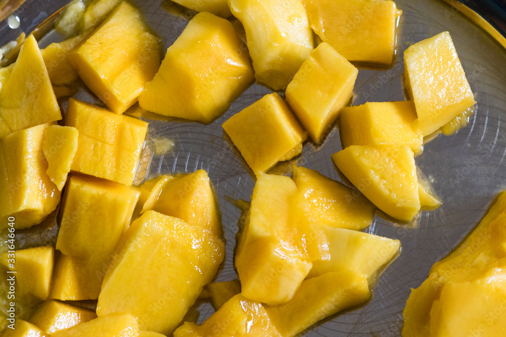 Mango pieces placed on a plate Mango pieces placed on a plate